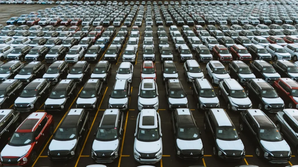 Rows of vehicles staged in a large auction or inventory lot