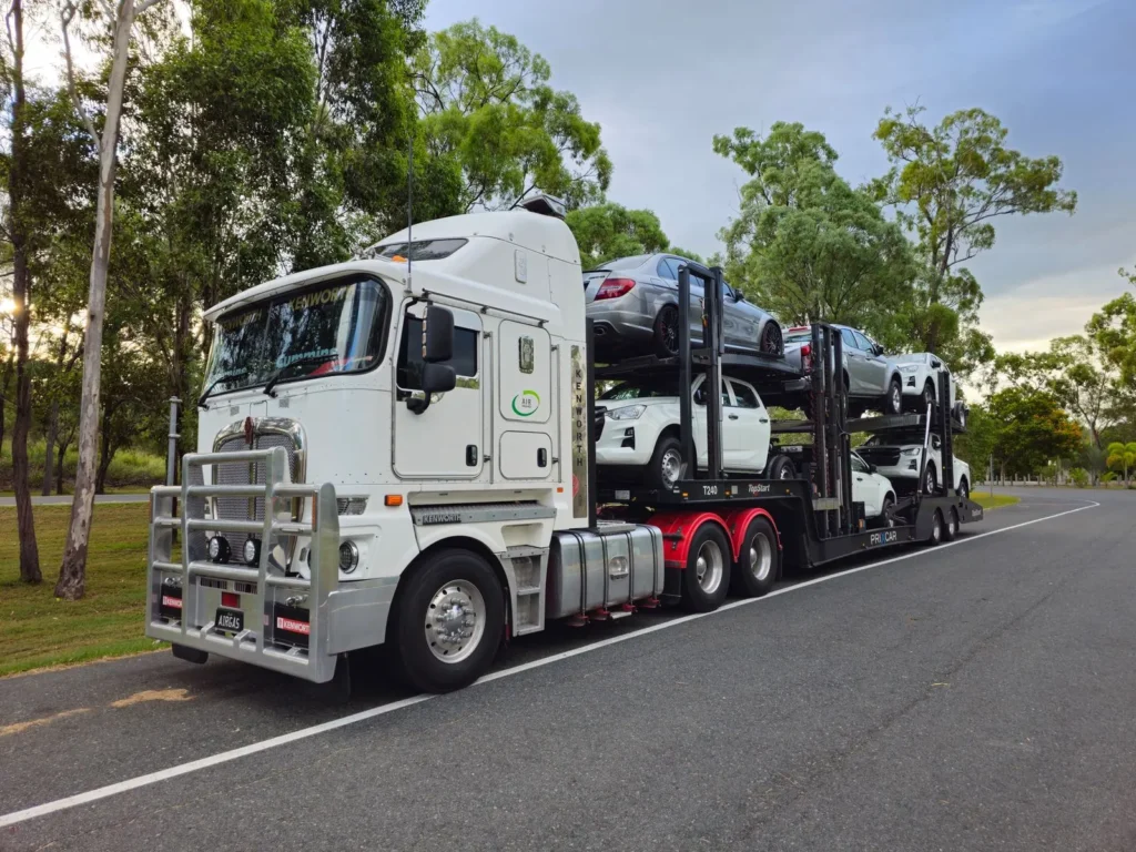 Multi-car carrier truck transporting cars and pickup trucks on a road