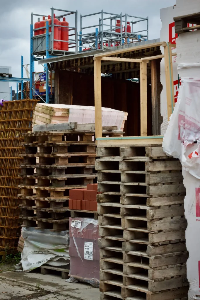 Wooden pallets and building materials staged at a construction site
