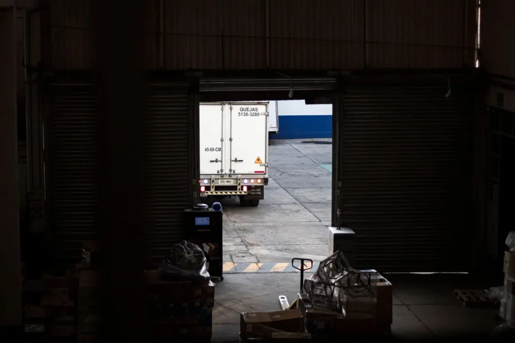 Delivery truck leaving a warehouse loading dock