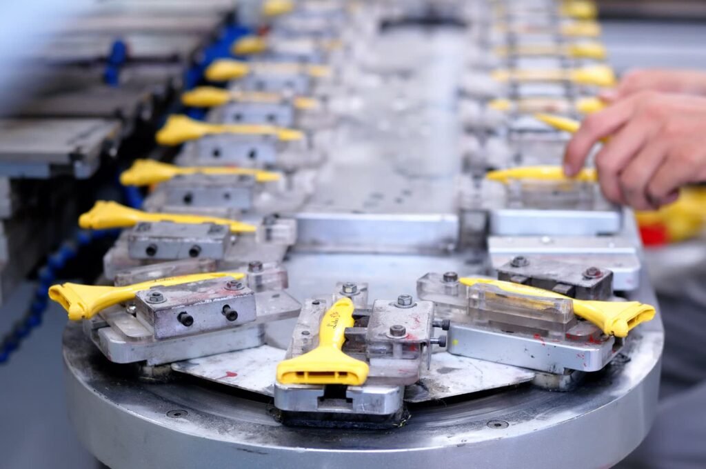 Metal components moving through an assembly station