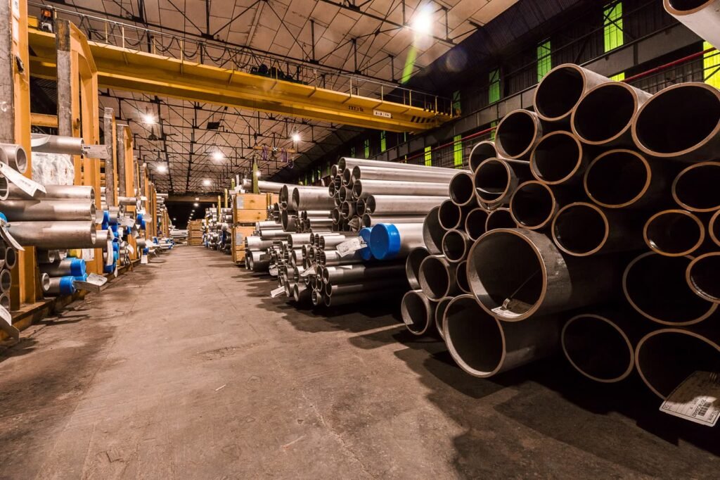 Stacked metal pipes inside an industrial warehouse