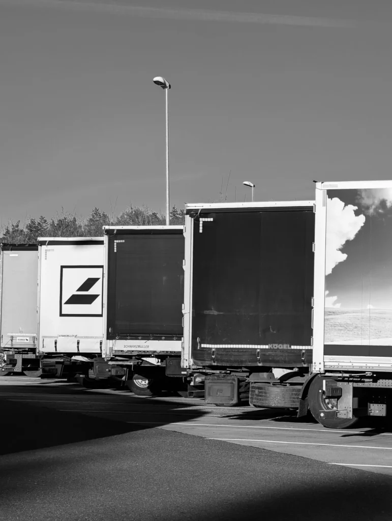 Line of enclosed freight trailers parked at a truck stop