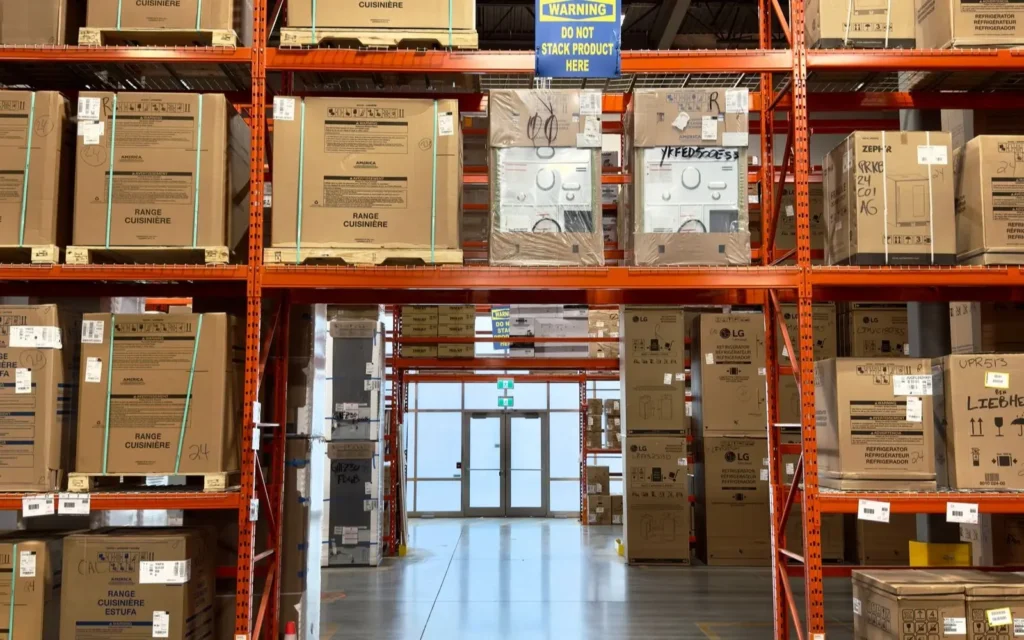 Palletized cartons stored on orange warehouse racks