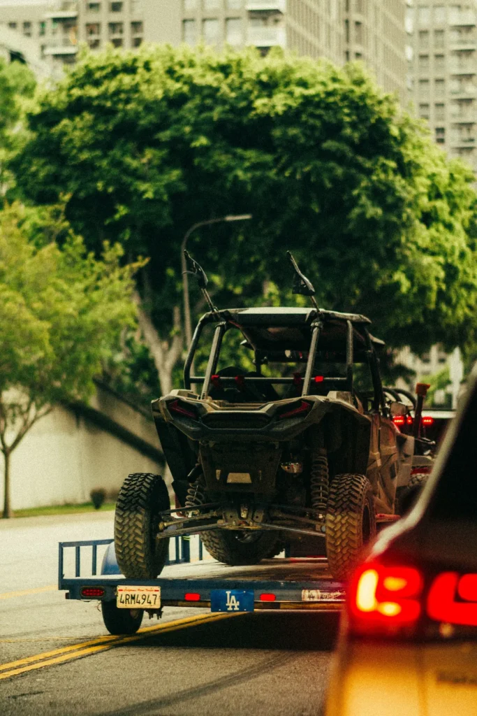 Modified off-road vehicle secured on a small transport trailer