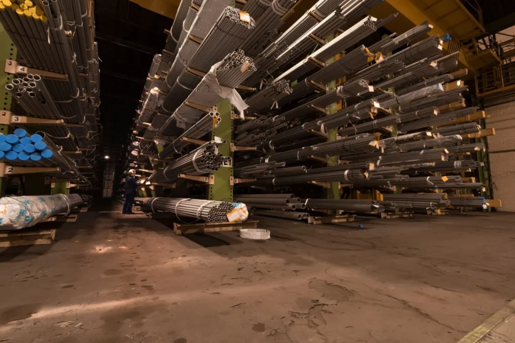 Steel pipes stored on racks in an industrial warehouse
