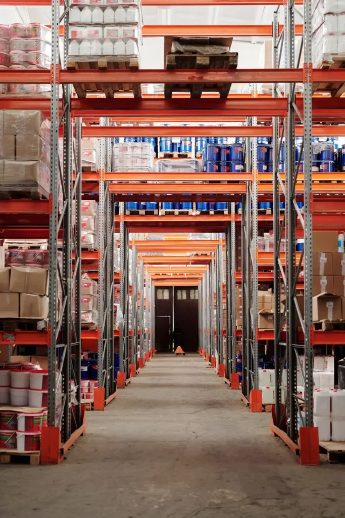 Pallets of packaged goods stored on tall warehouse shelving
