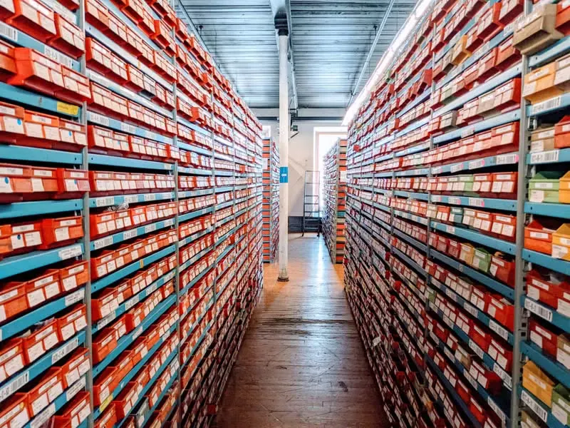 Rows of shoe boxes organized on warehouse shelves