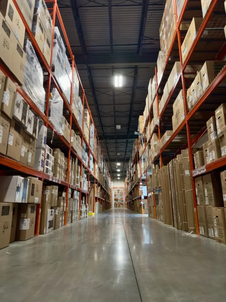 Long warehouse aisle lined with boxed merchandise